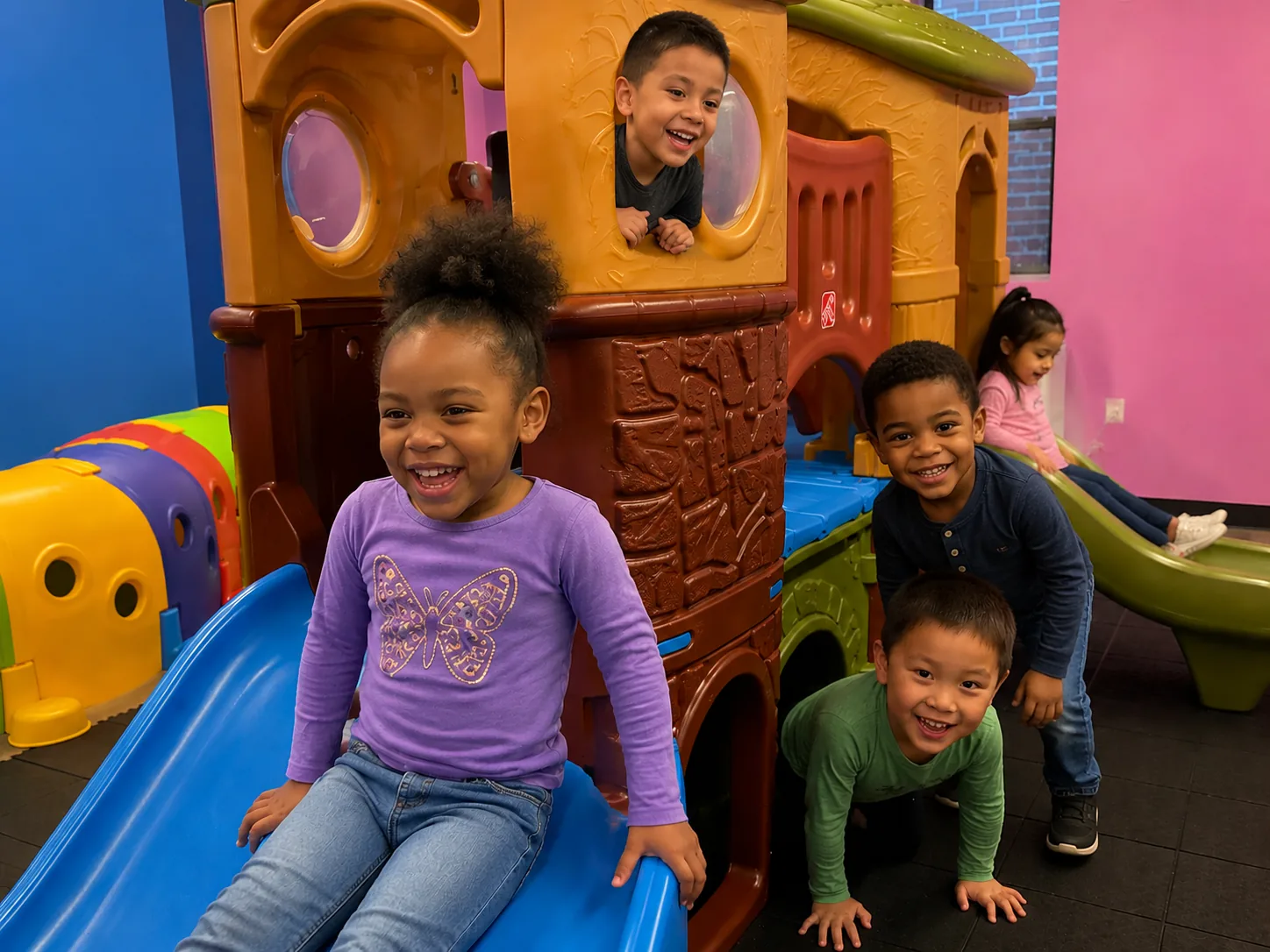 Children playing on a colorful indoor playground
